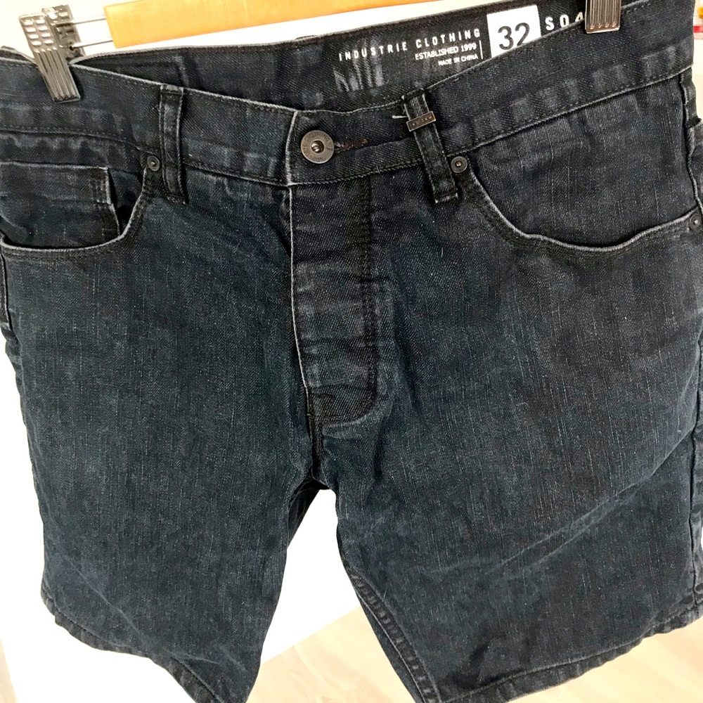 Black slim-fit denim shorts.
